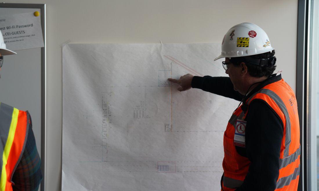 worker pointing at a diagram