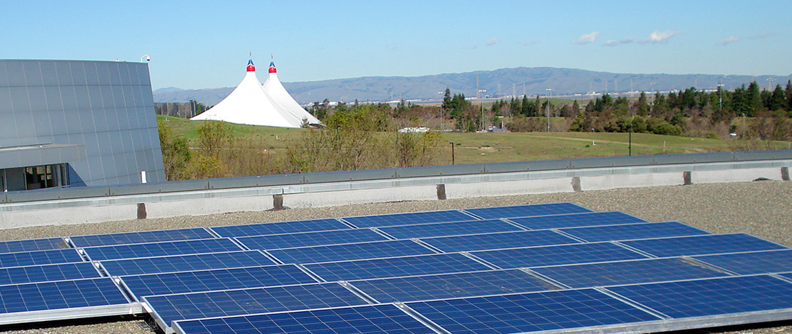 Overview of the rooftop solar PV system installation with the iconic Shoreline Amphitheatre tent sails in the background