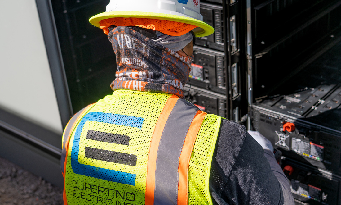 A Cupertino Electric employee installing a BESS.