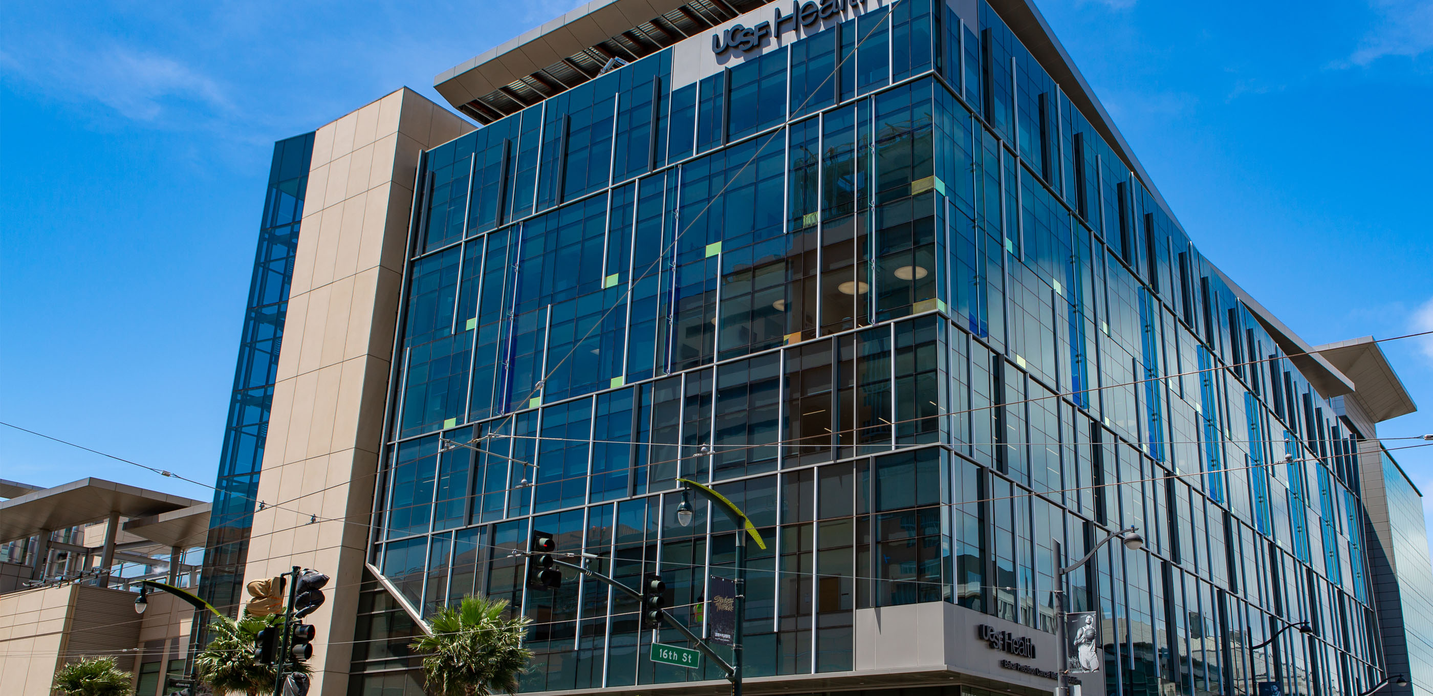 Large UCSF medical building with blue windows floor to ceiling, on a corner.